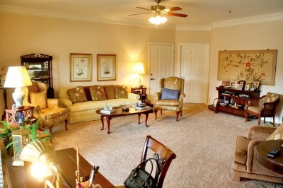 Living area with coffee table, writing desk, couch and chairs
