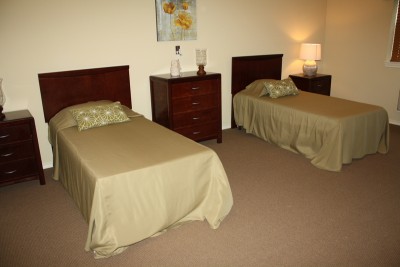 Bedroom with two twin beds, dressers and side tables