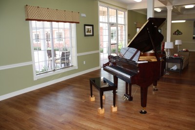 Large room with window and piano