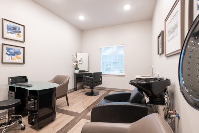salon room with hair washing station and nail painting station