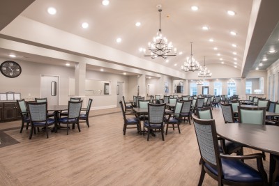 Long dining area with many tables and chairs